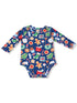 Blue long-sleeve baby onesie with colorful holiday-themed prints like gingerbread, gifts, and candy canes.