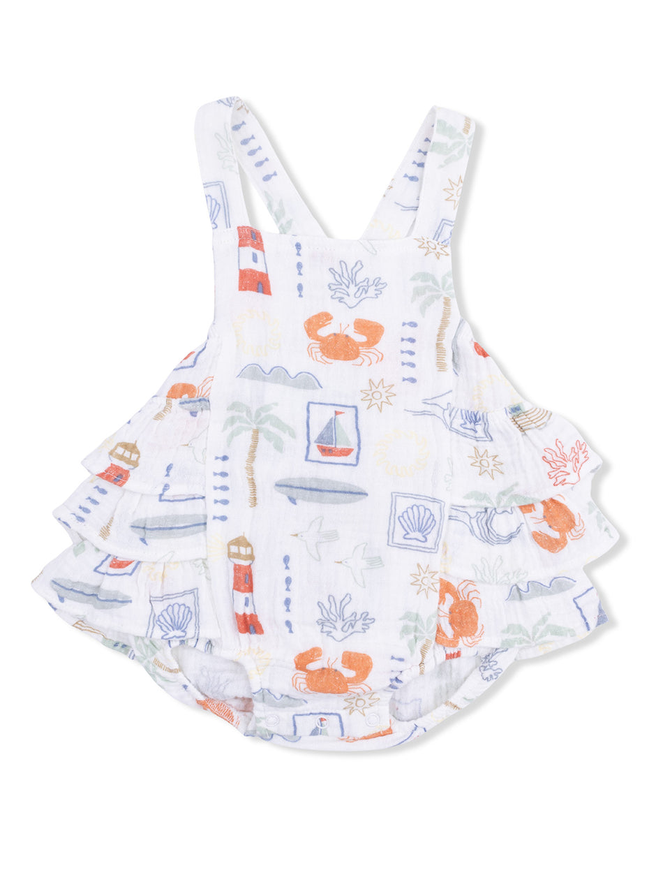 White dress with colorful beach-themed patterns, including crabs, lighthouses, and seashells. Perfect for summer fun.