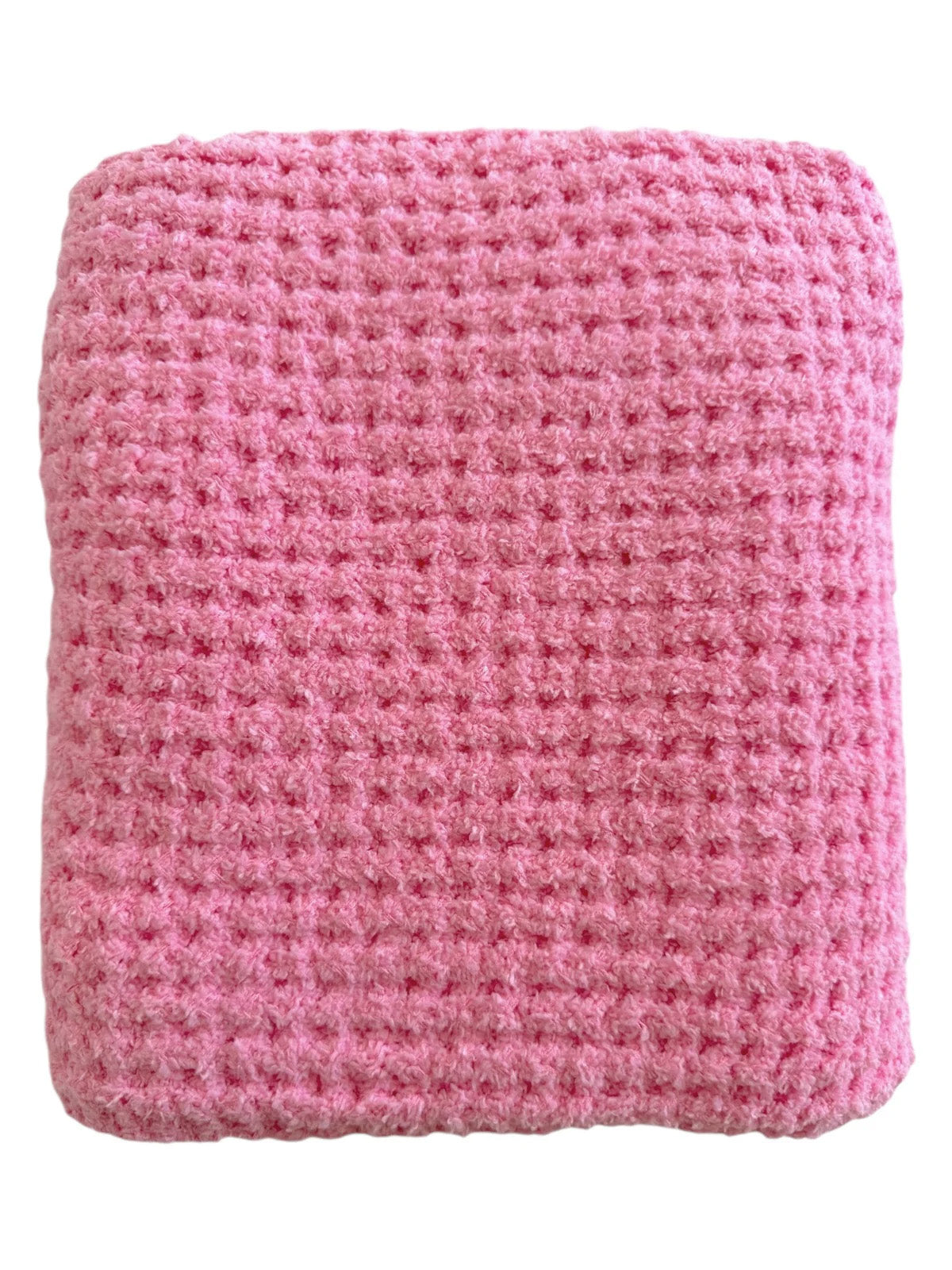 Soft pink woven blanket with a textured pattern, folded neatly for cozy use.