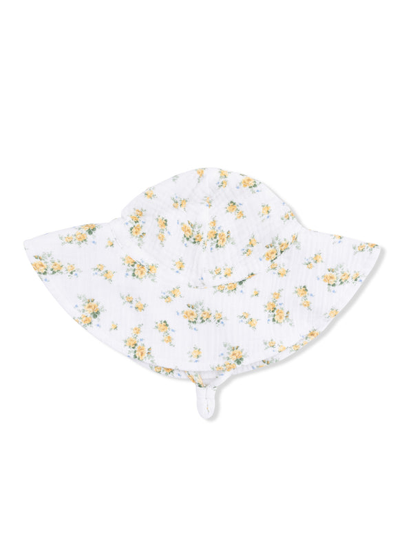 Floral white sun hat with yellow flowers, wide brim, and chin strap. Perfect for sunny days outdoors.