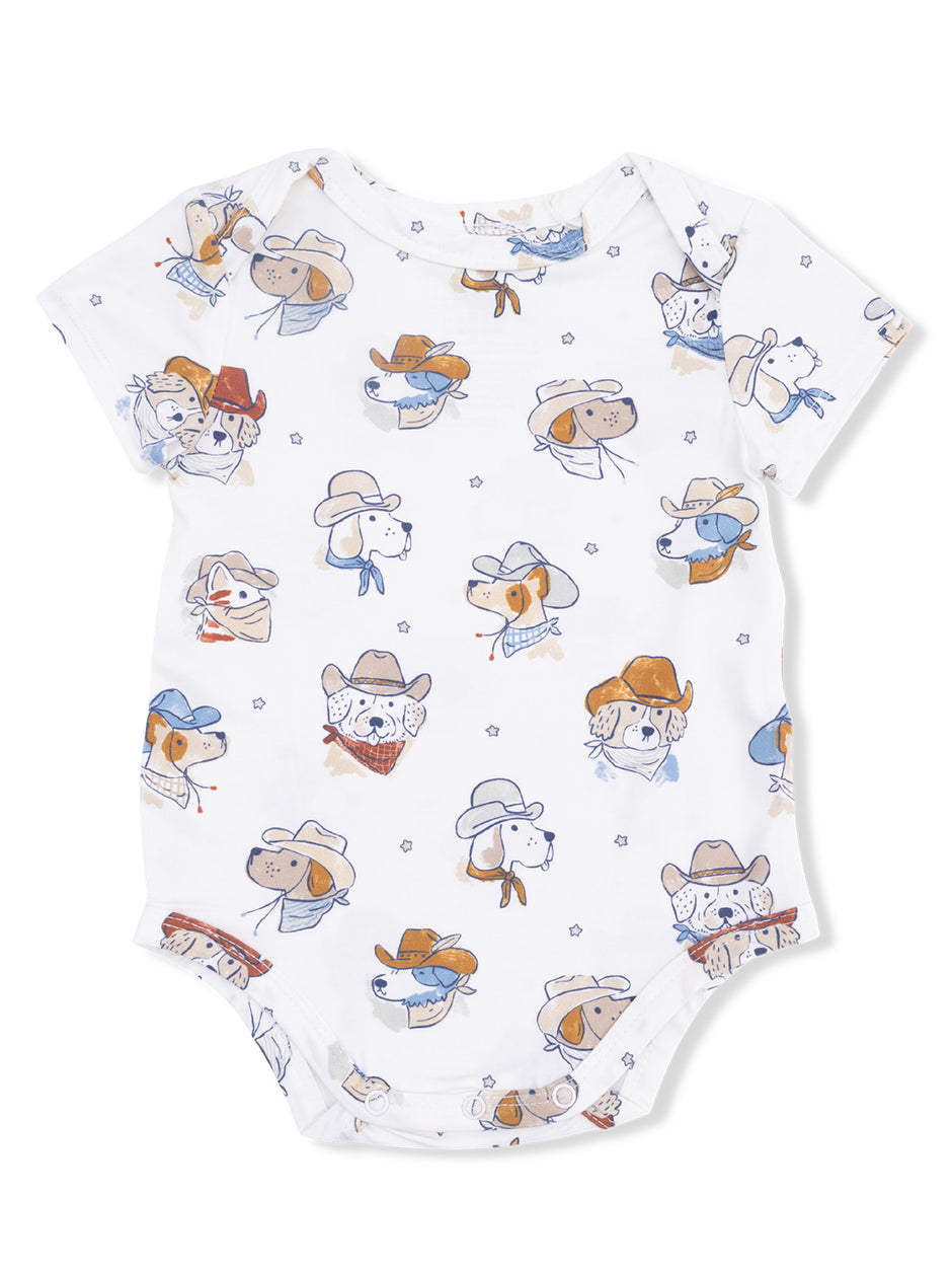 White onesie featuring playful, cowboy-themed dog illustrations in orange and blue tones.