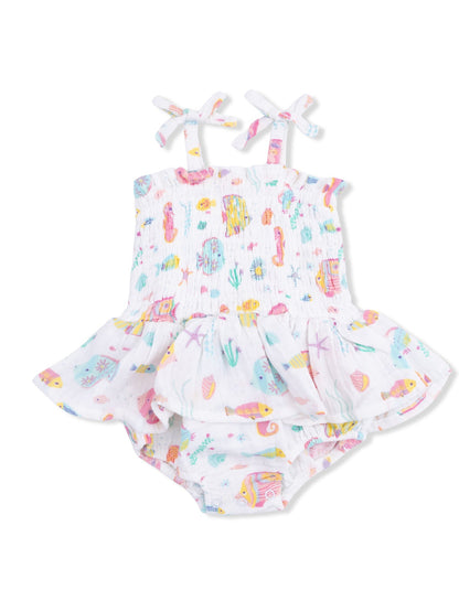 White toddler swimsuit with colorful sea-themed prints and ruffled skirt; perfect for summer fun.