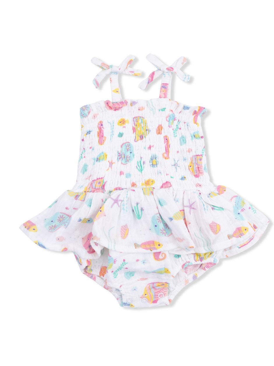 White toddler swimsuit with colorful sea-themed prints and ruffled skirt; perfect for summer fun.