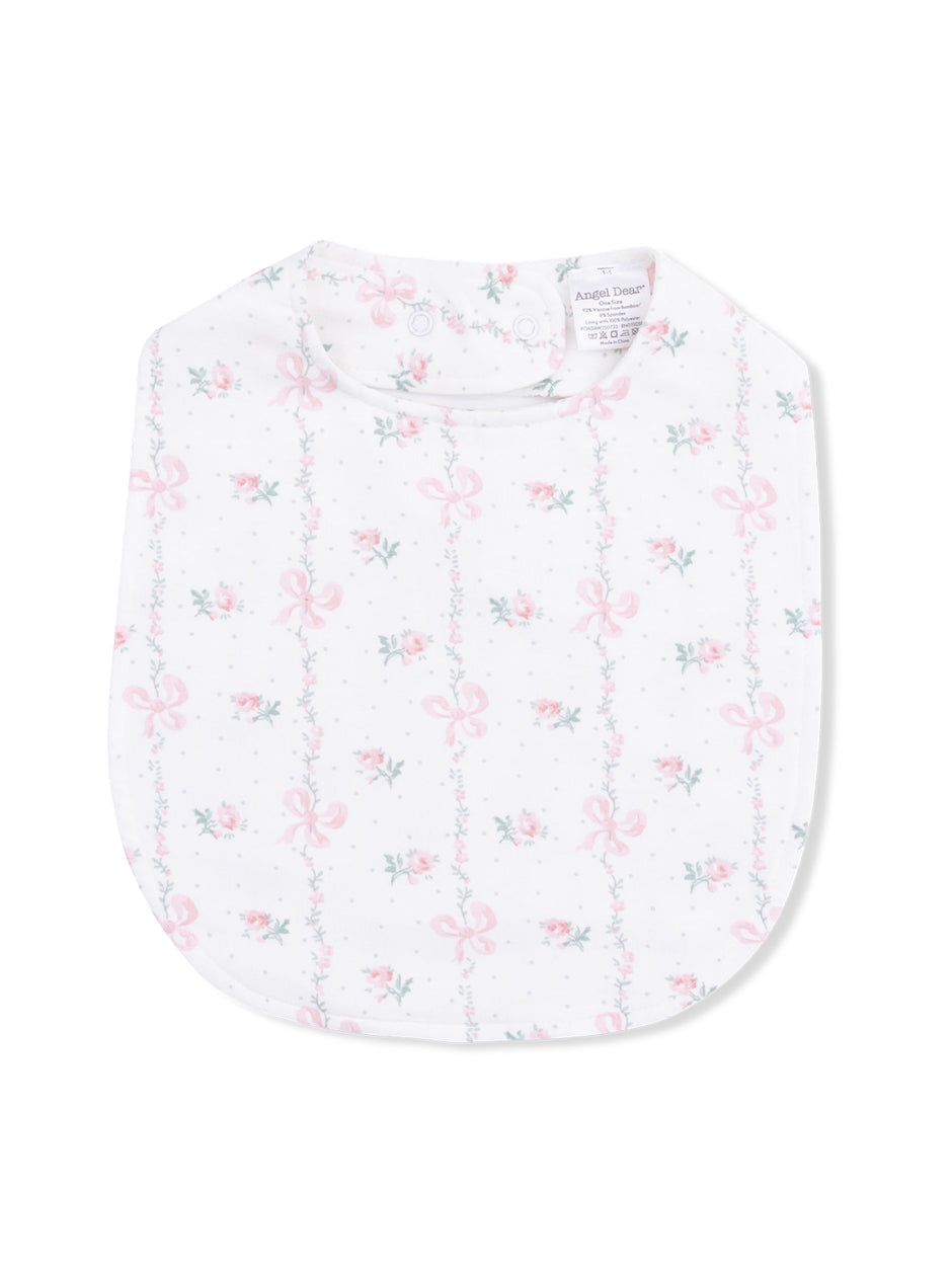 Floral baby bib with pink bows and green vines on a white background.
