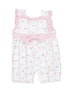 Pink floral romper with ruffled straps and a large bow, perfect for toddlers or infants.