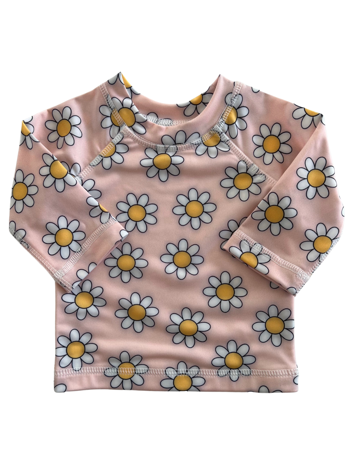 Pink long-sleeve shirt with a white and yellow daisy print, featuring snap buttons on the shoulder.