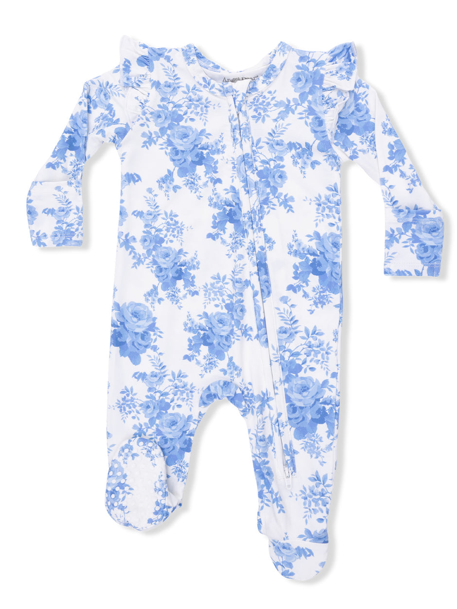 White baby onesie with blue floral print and ruffled shoulders, featuring a front zipper and footed design.