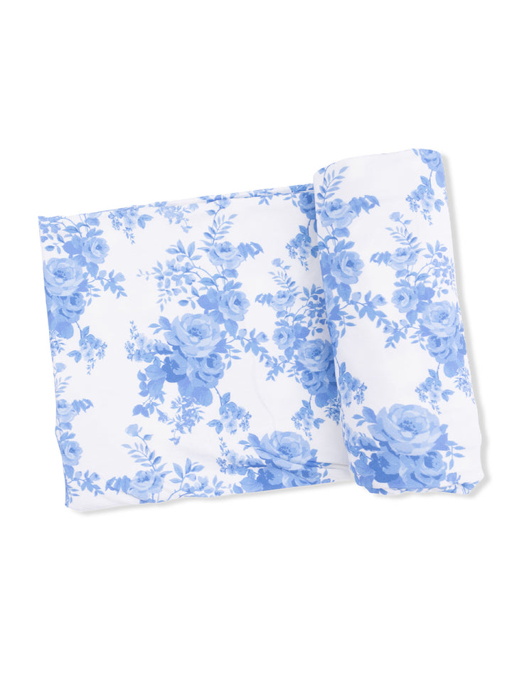 Blue floral patterned fabric folded neatly on a white background.