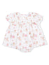 White baby dress with pastel animal prints and floral designs, featuring short ruffled sleeves and a snap bottom.