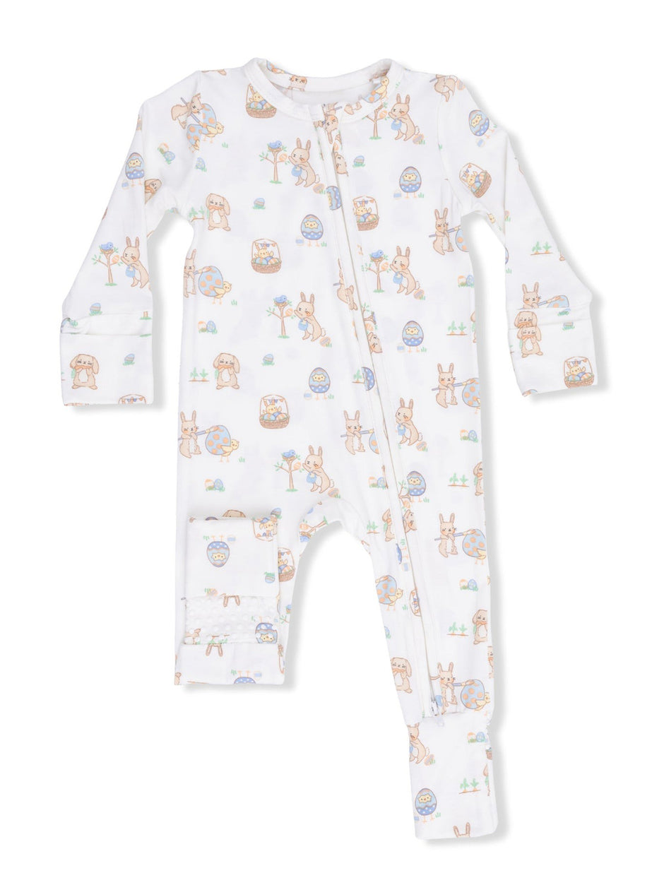 White baby onesie with pastel animal prints, featuring rabbits, eggs, and flowers, with a front zipper closure.