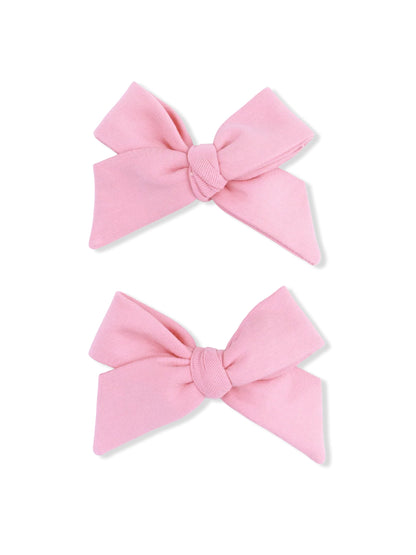 Two pink fabric hair bows with knot detail, displayed side by side on a white background.