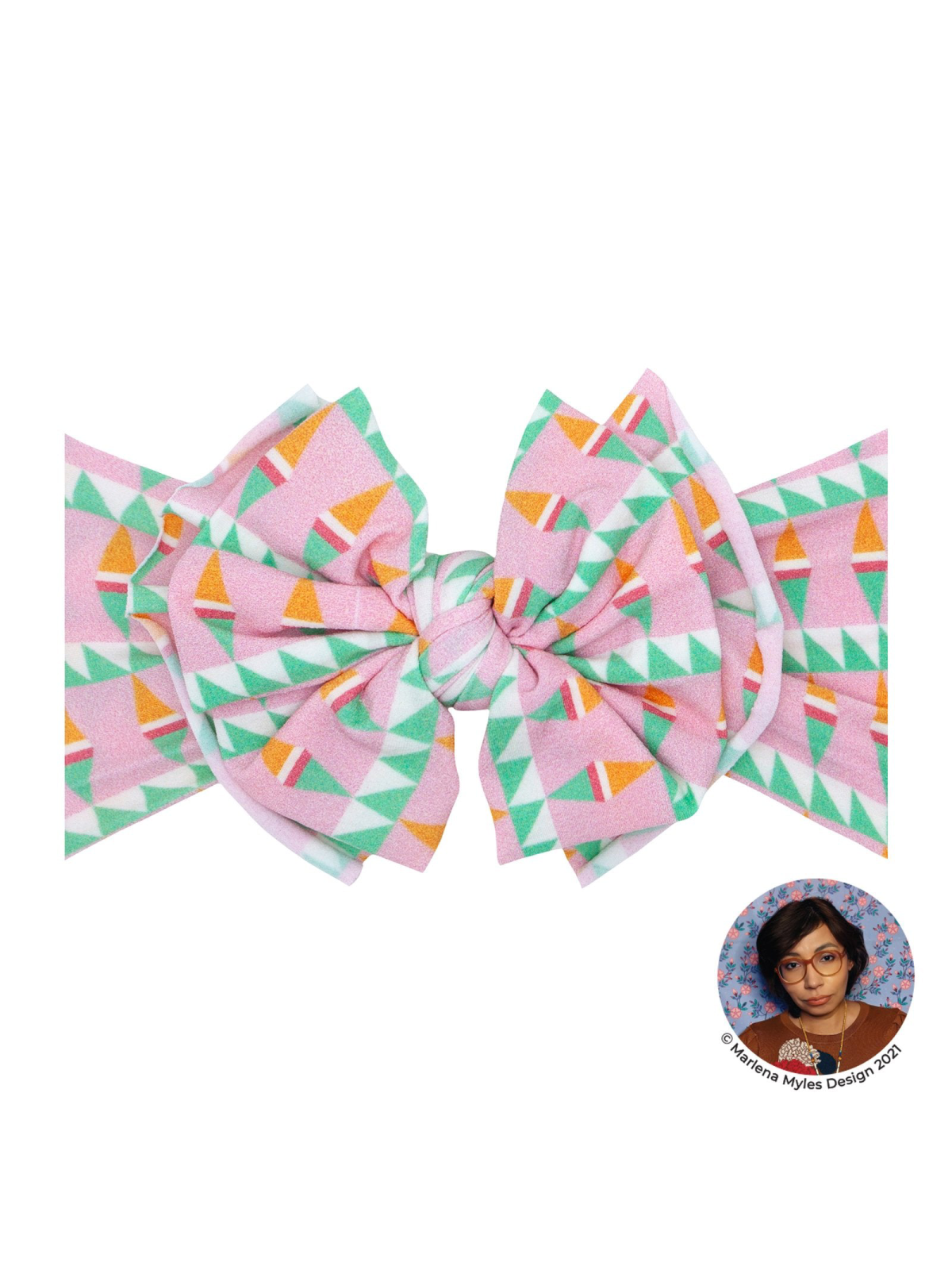 Pink geometric bow with green and orange accents, designed by Mariena Myles.
