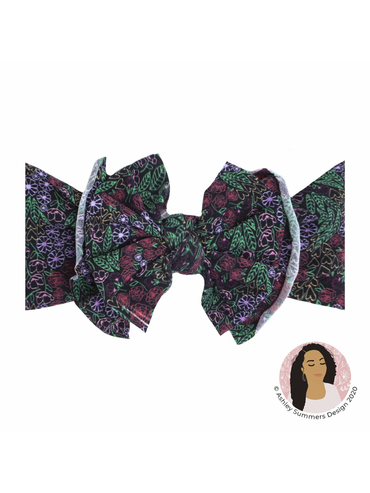 Colorful floral bow hair accessory on a dark background with a logo in the corner.