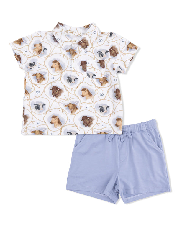 Children's outfit featuring a short-sleeve shirt with animal print and light blue shorts. Comfortable and stylish.