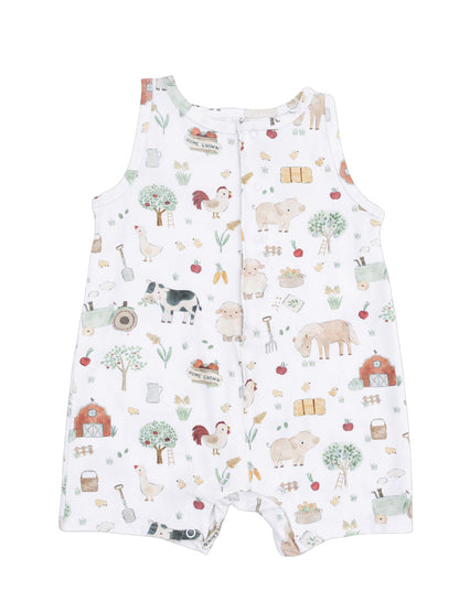 White infant romper featuring a playful farm animal print with trees, vegetables, and barn illustrations.