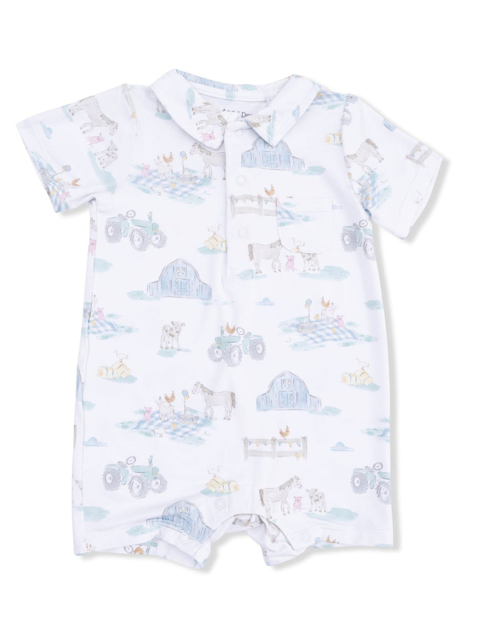 Baby romper with farm-themed print featuring tractors, animals, and barns on a light background.