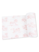 Pink and white patterned fabric featuring farm animal scenes, rolled with a flat section visible.