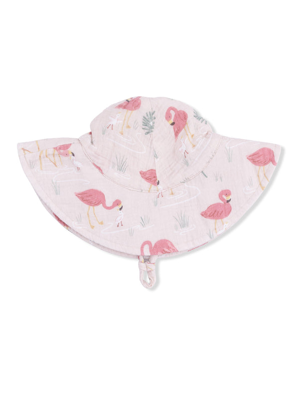 Pink sun hat with flamingo patterns, featuring a wide brim and a chin strap for secure fit.