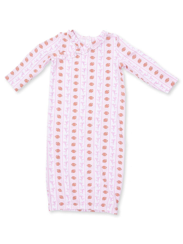 Pink baby dress with long sleeves and a playful pattern of yarn balls and bows. Ideal for comfortable wear.