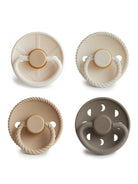 Four silicone pacifiers in neutral colors and various designs. Ideal for infants and toddlers.