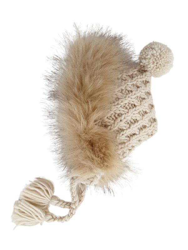 Knitted beige hat with a fluffy pom-pom and tassels, perfect for winter wear.