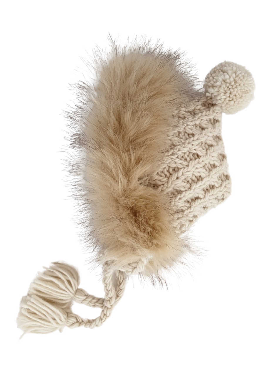 Knitted beige hat with a fluffy pom-pom and tassels, perfect for winter wear.