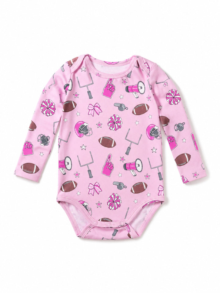 Pink long-sleeve onesie with sports-themed prints including footballs, pom-poms, and cheer accessories.