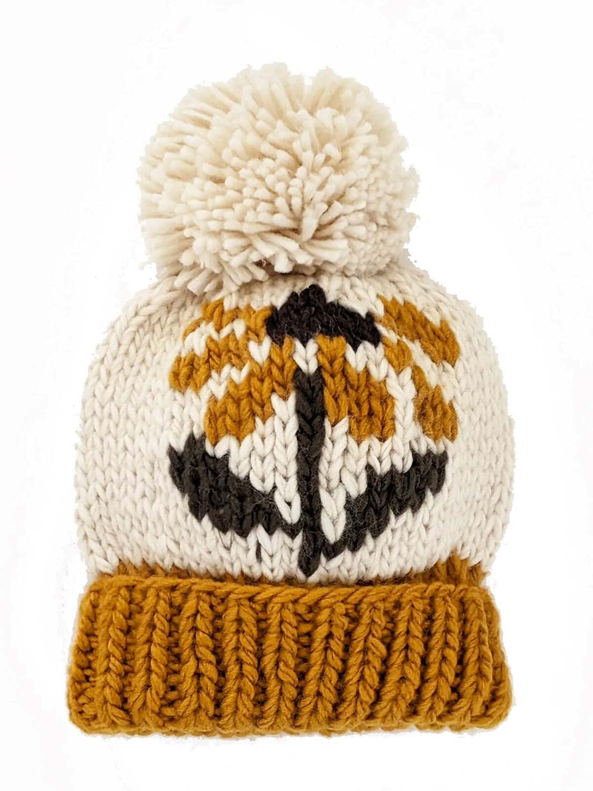 Knitted beanie with a pom-pom, featuring a pumpkin design in orange, white, and black.