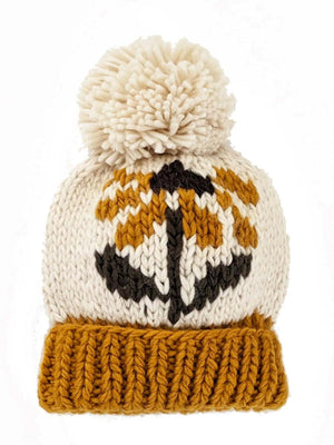 Knitted beanie with a pom-pom, featuring a pumpkin design in orange, white, and black.