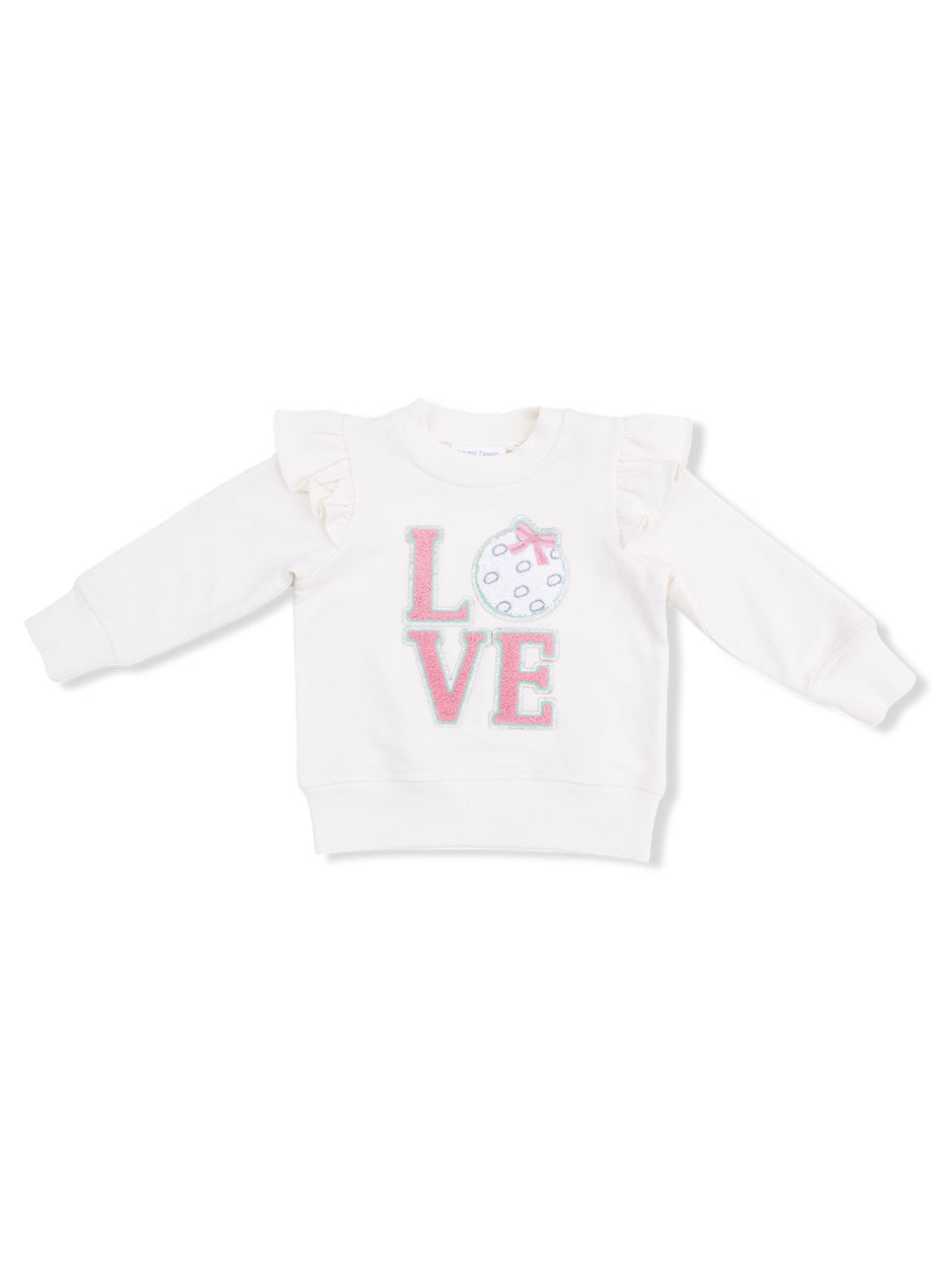 White sweatshirt with ruffle sleeves featuring the word "LOVE" and a decorative polka dot design.