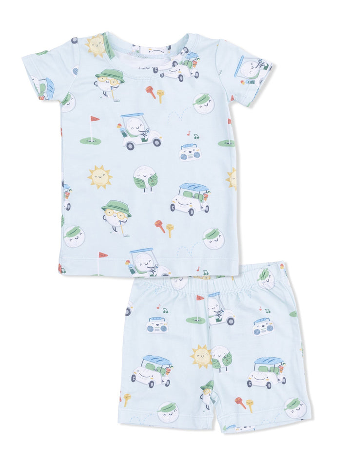 Light blue children's pajama set featuring playful cartoon characters, golf tees, and sun motifs.