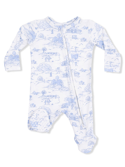 White baby onesie with blue landscape print, featuring long sleeves and a front zipper.