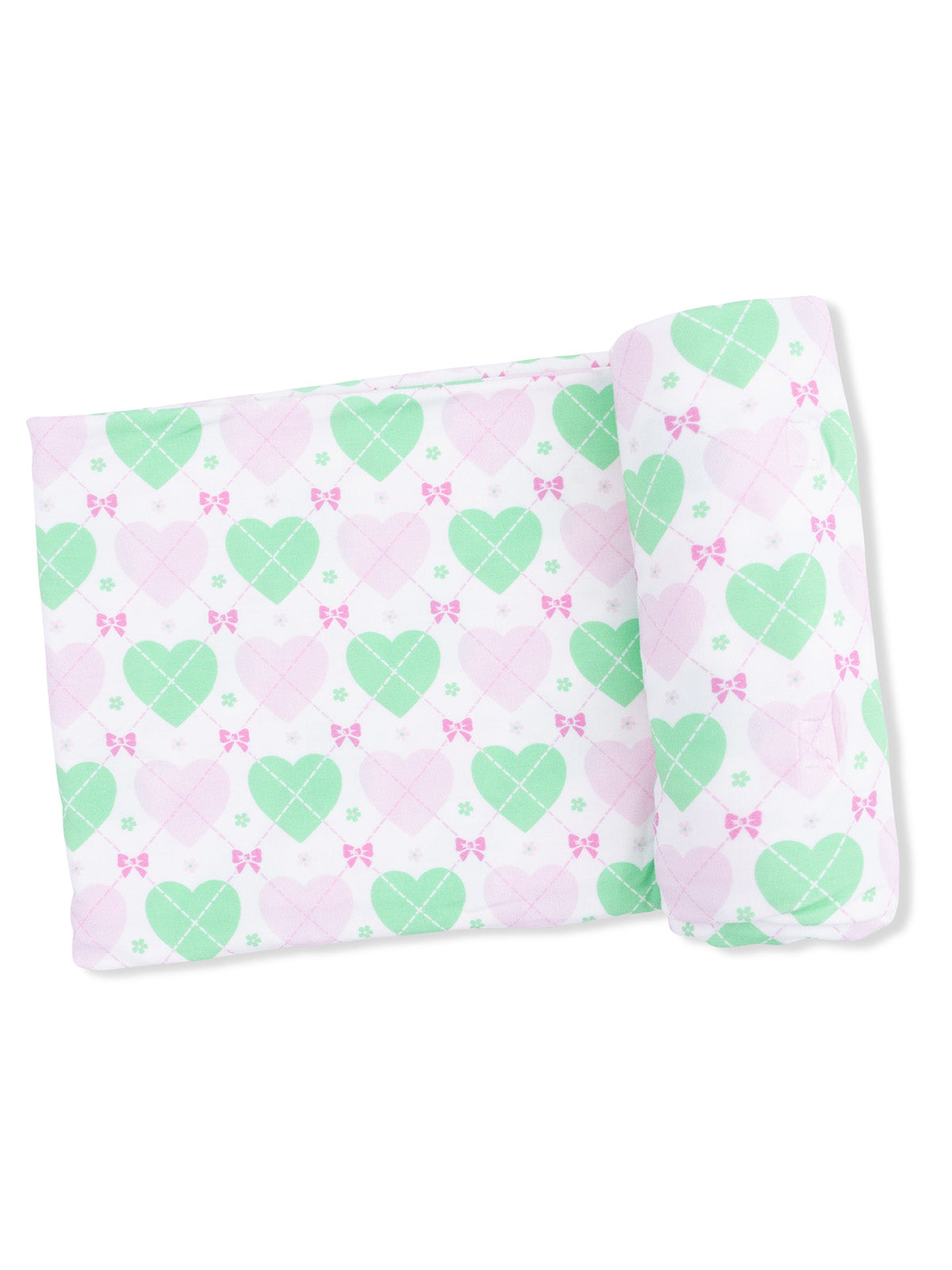 Decorative pillow with a pastel heart pattern in pink and green, featuring bows and floral motifs.