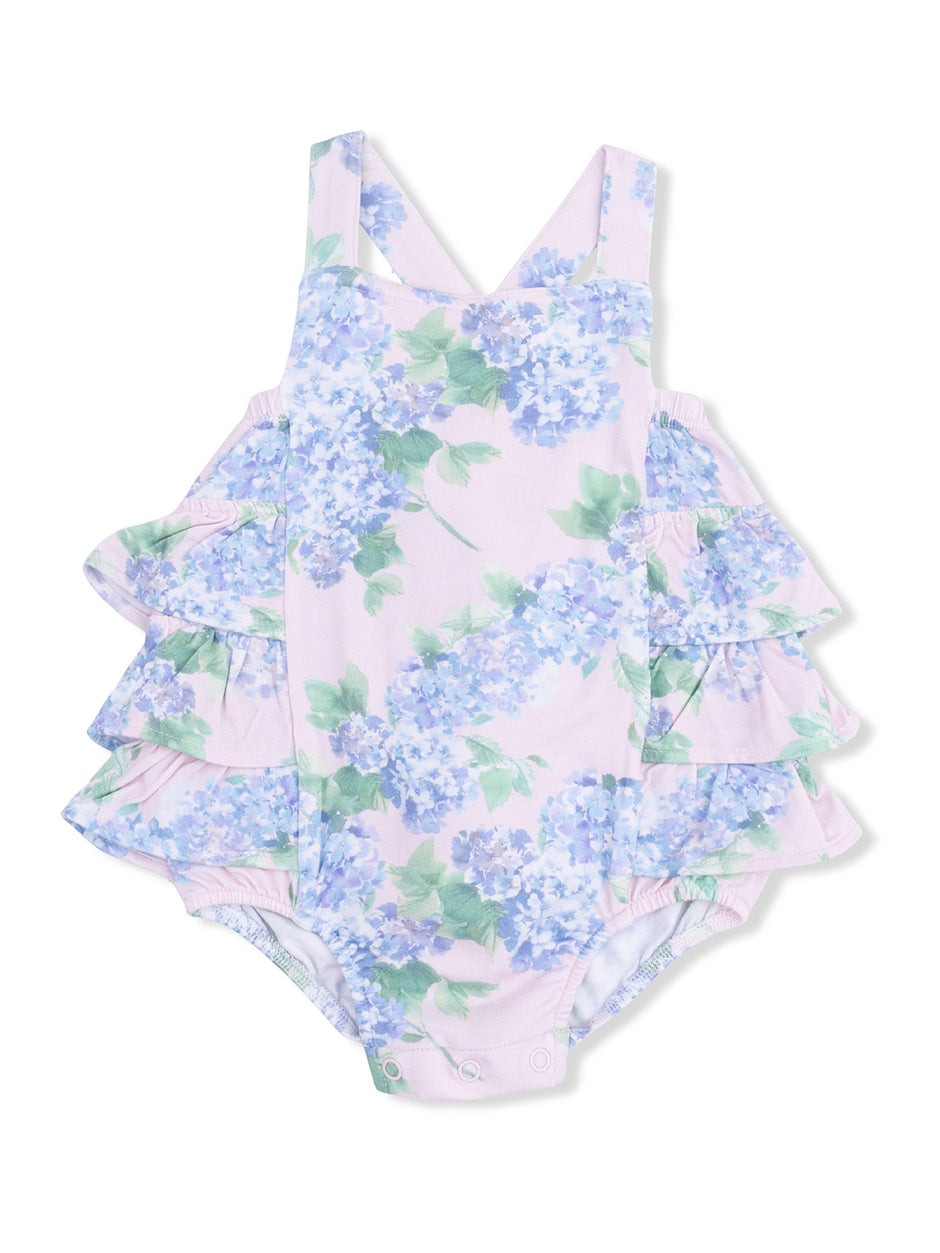 Floral baby swimsuit with ruffled sides in pastel pink, featuring blue and green hydrangea patterns.
