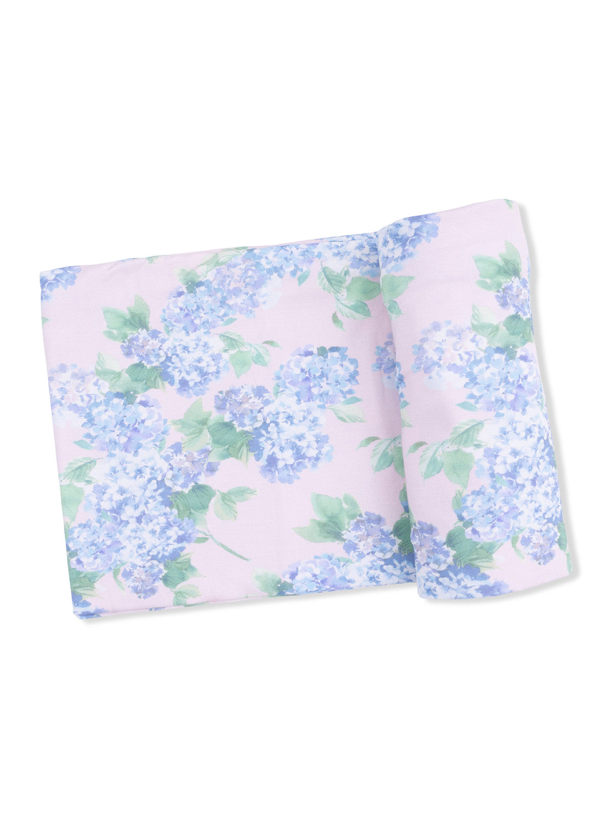 Floral fabric featuring light pink background with blue hydrangea flowers and green leaves, folded neatly.