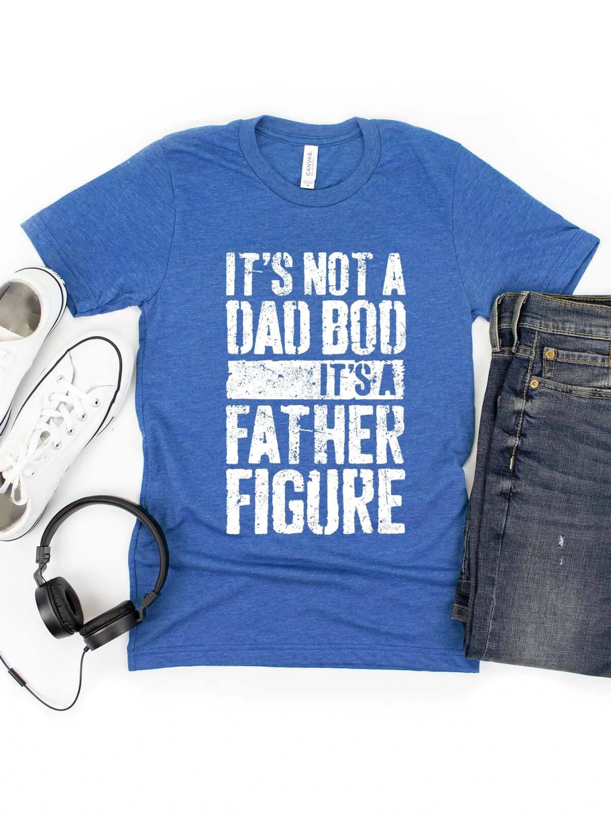 Blue T-shirt with text: “It’s not a dad bod, it’s a father figure,” paired with sneakers and jeans.