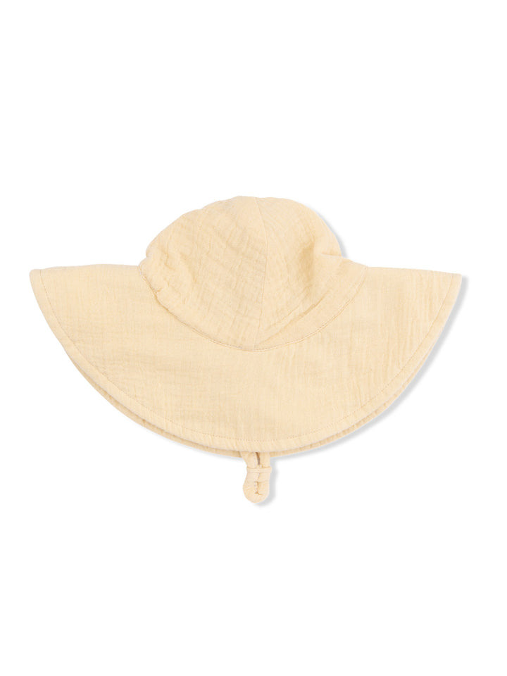 Light yellow sun hat with a wide brim and adjustable strap, positioned flat on a white background.