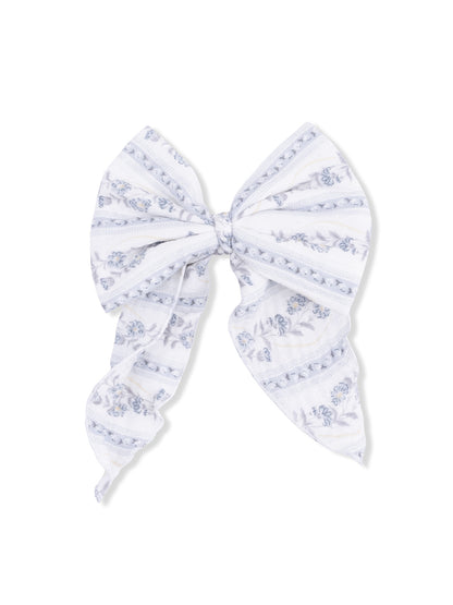 White bow with blue floral patterns and striped design, perfect for hair accessories or decorative uses.