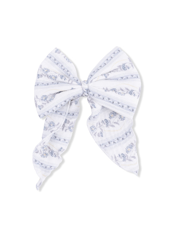 White bow with blue floral patterns and striped design, perfect for hair accessories or decorative uses.