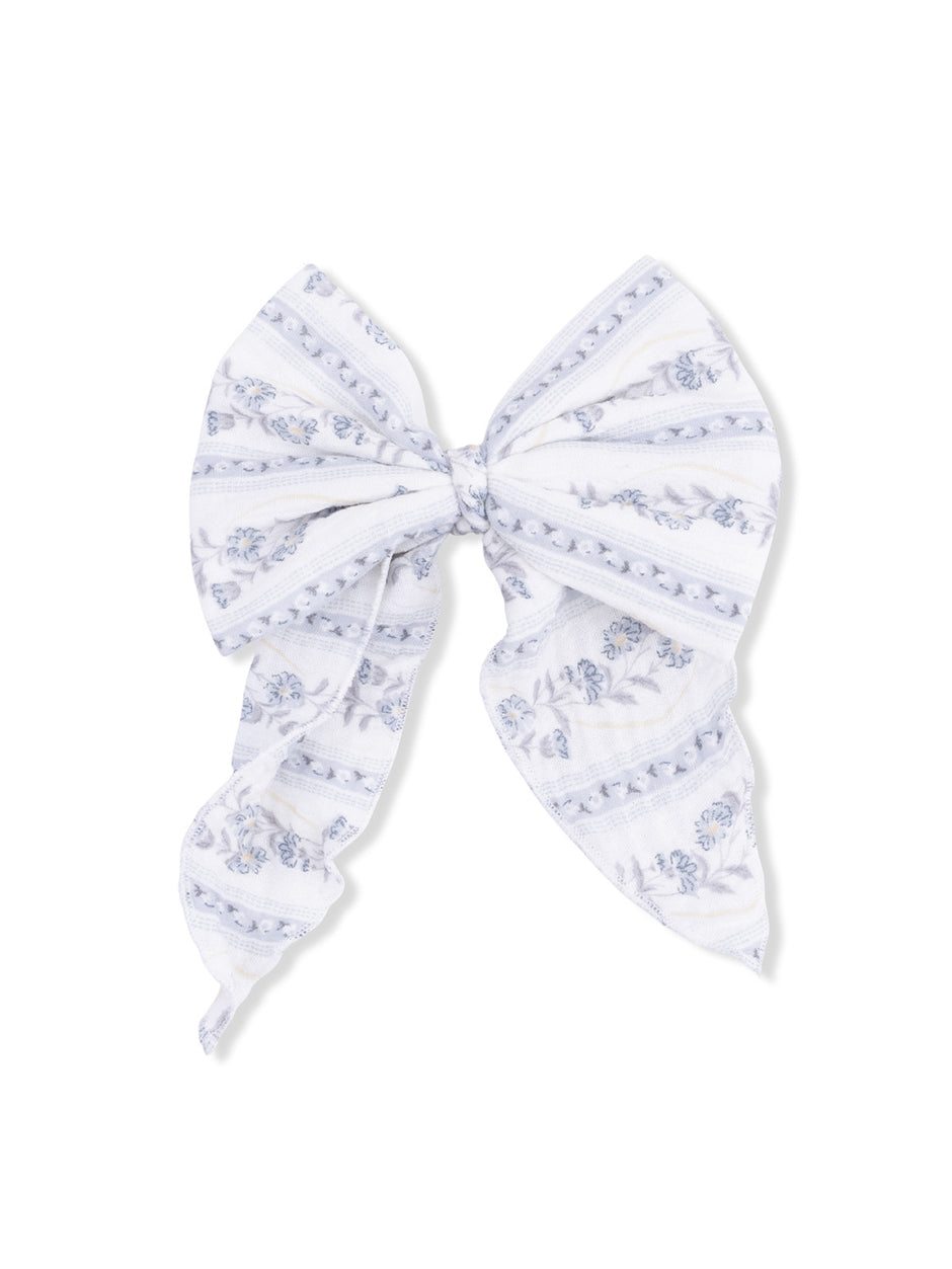 White bow with blue floral patterns and striped design, perfect for hair accessories or decorative uses.