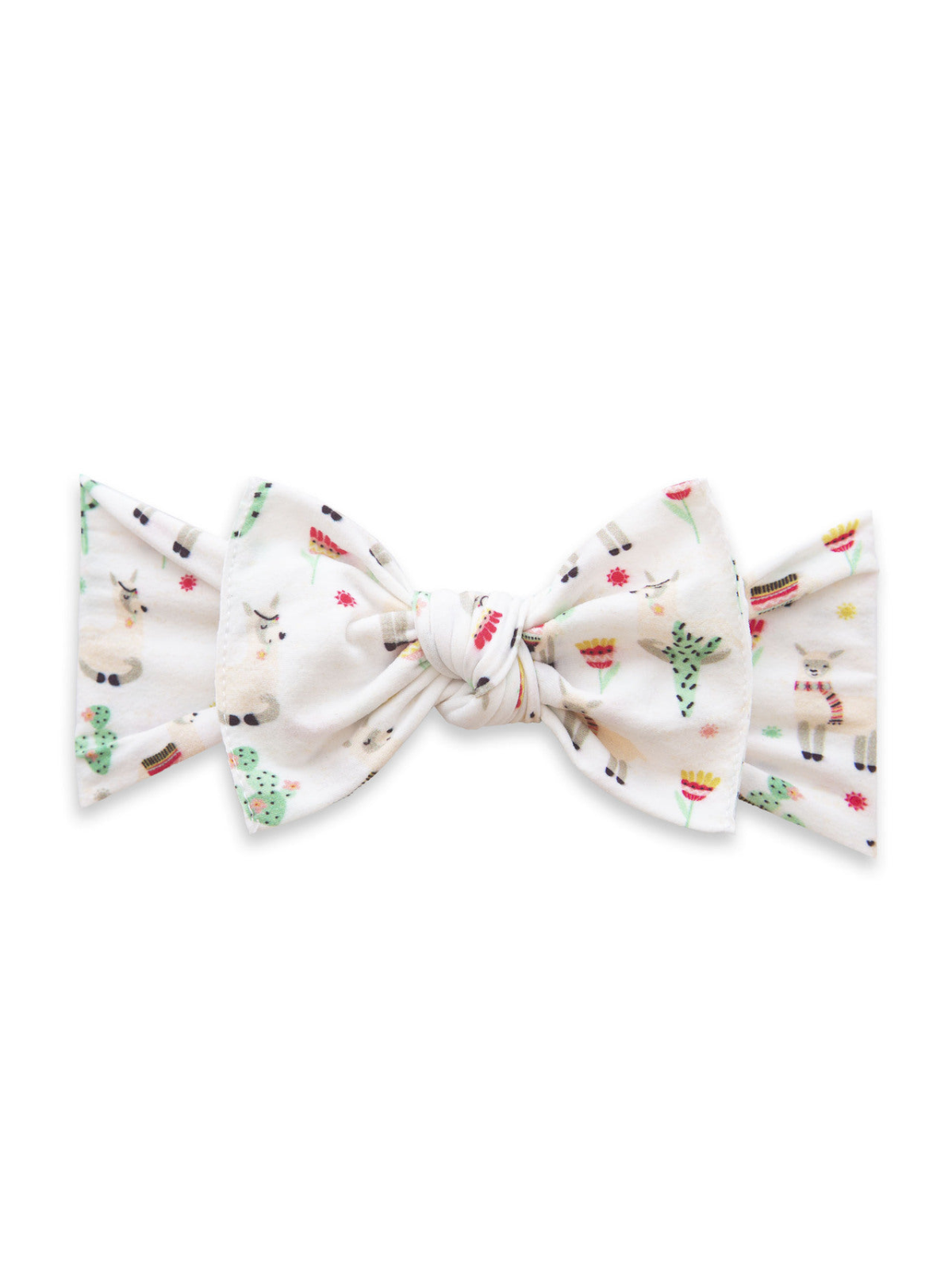 White bow adorned with playful patterns of llamas, cacti, and flowers on a soft fabric background.
