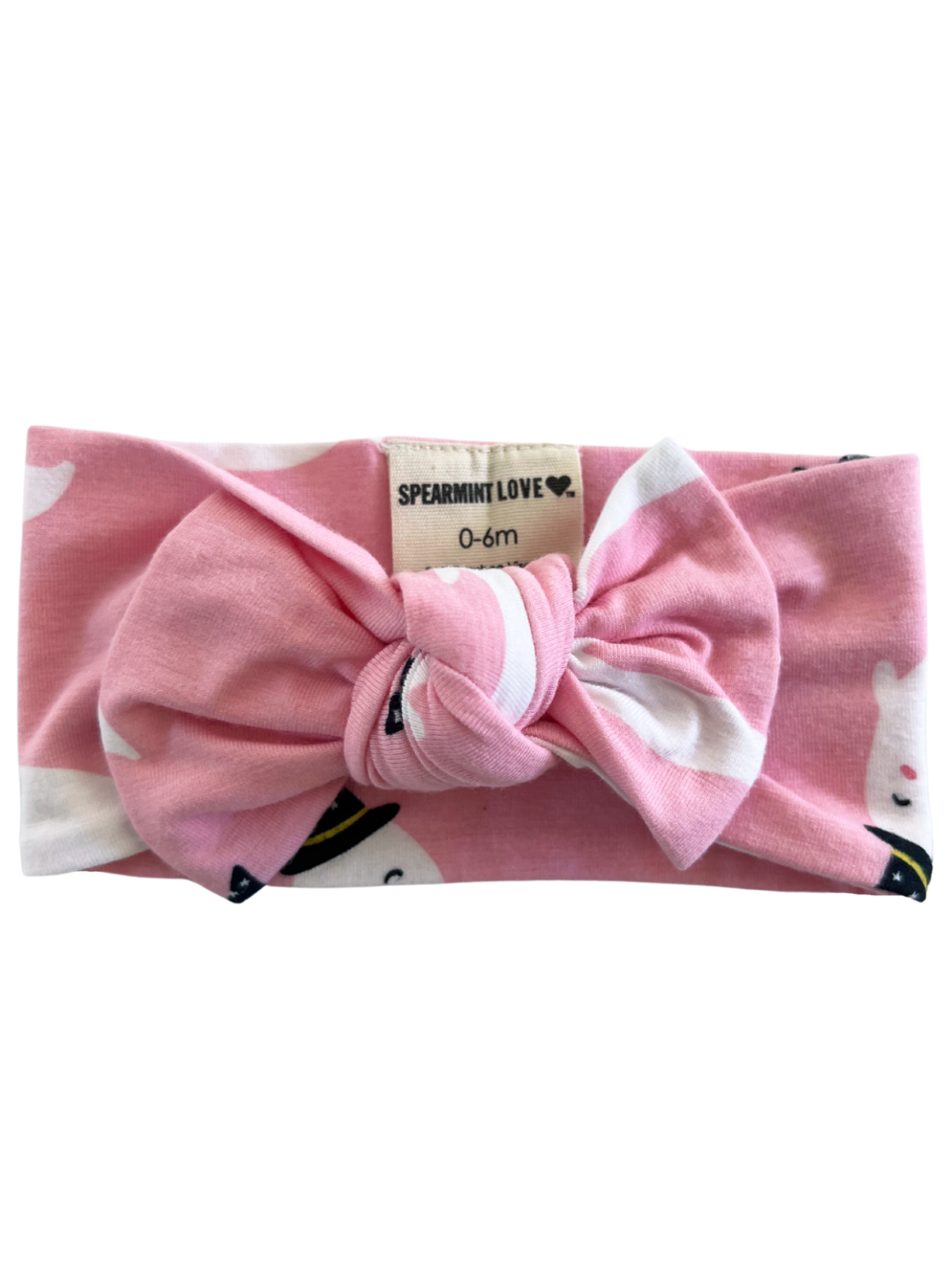 Pink baby headband with a bow, featuring ghost patterns, labeled "Spearmint Love, 0-6m."