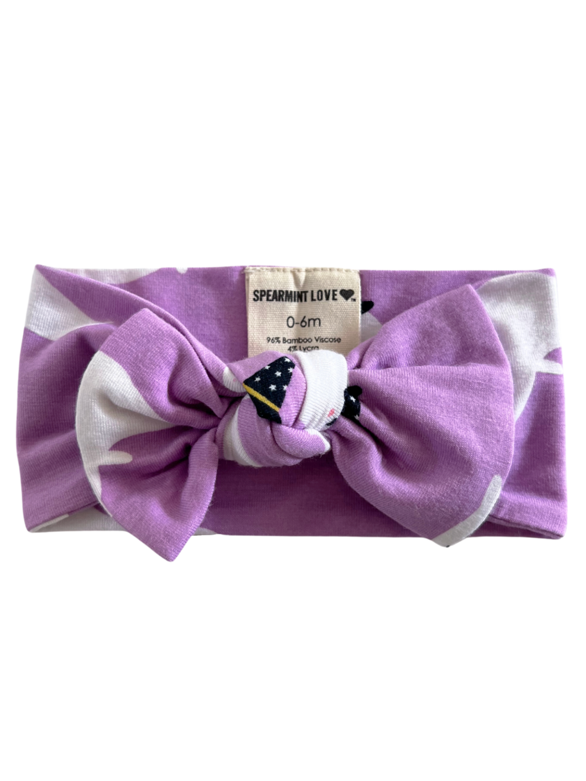 Purple baby headband with a bow and tag labeled "Spearmint Love." Suitable for ages 0-6 months.