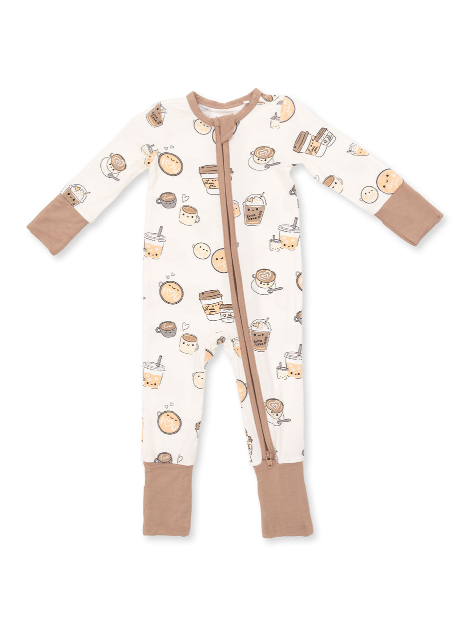 Child's cream onesie featuring cute food and drink illustrations, zip closure, and brown details.