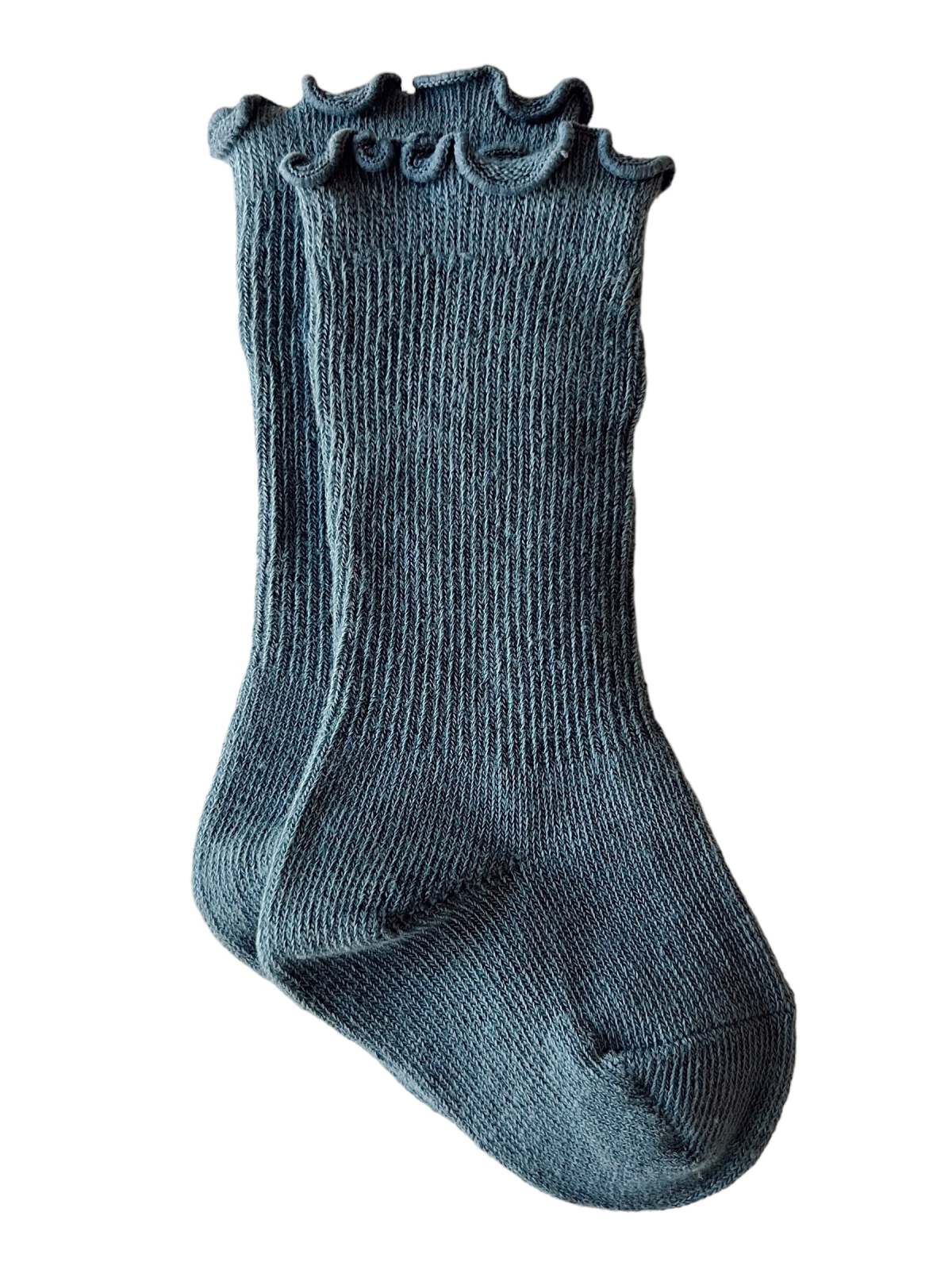 Pair of teal ribbed socks with a ruffled top, showcasing a soft and cozy design. Ideal for casual wear.