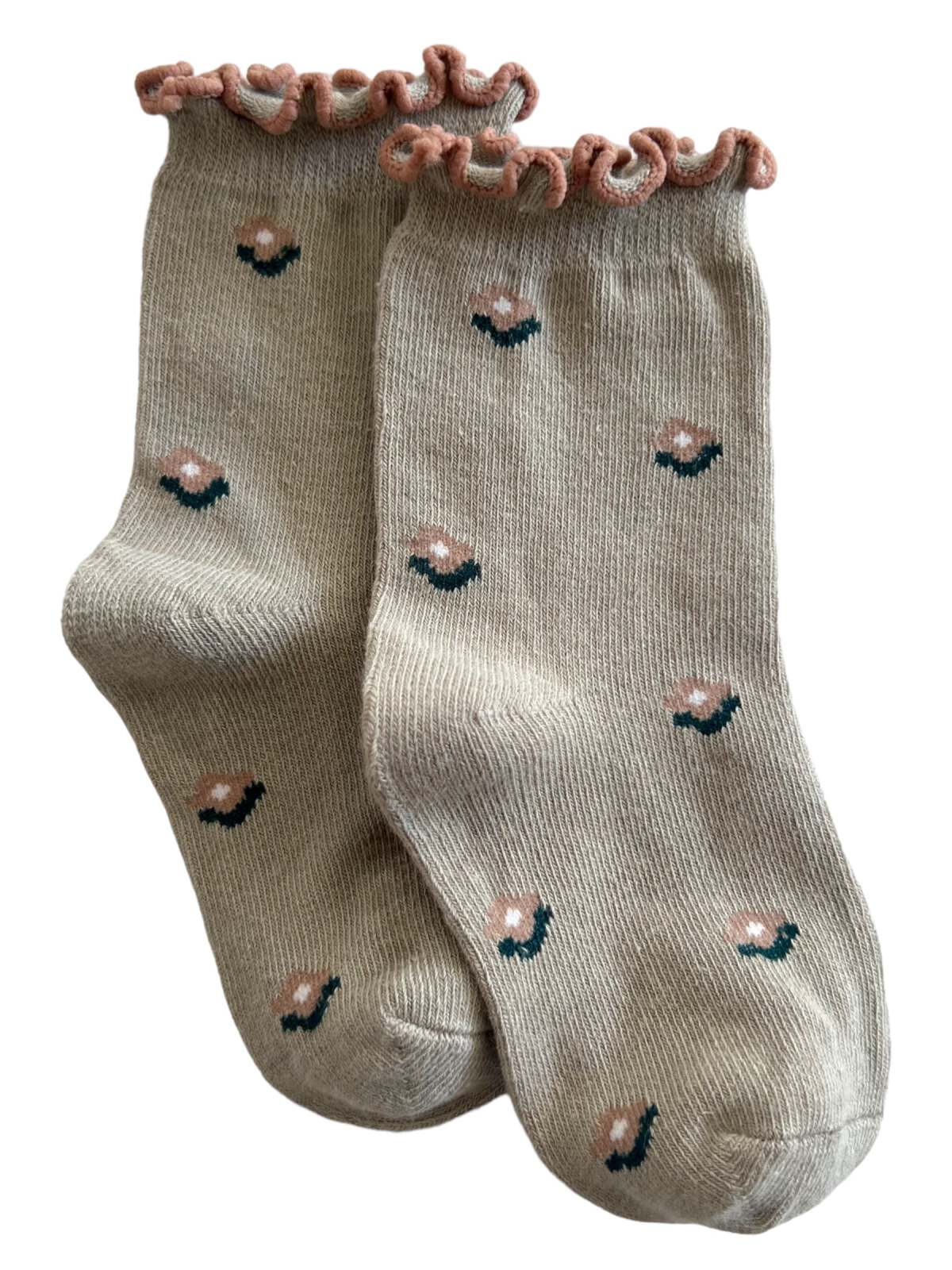 Beige socks with a pink ruffled top and floral designs in pink and green.