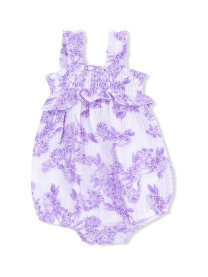 Lilac floral baby romper with ruffled straps and snap closure. Perfect for warm weather occasions.