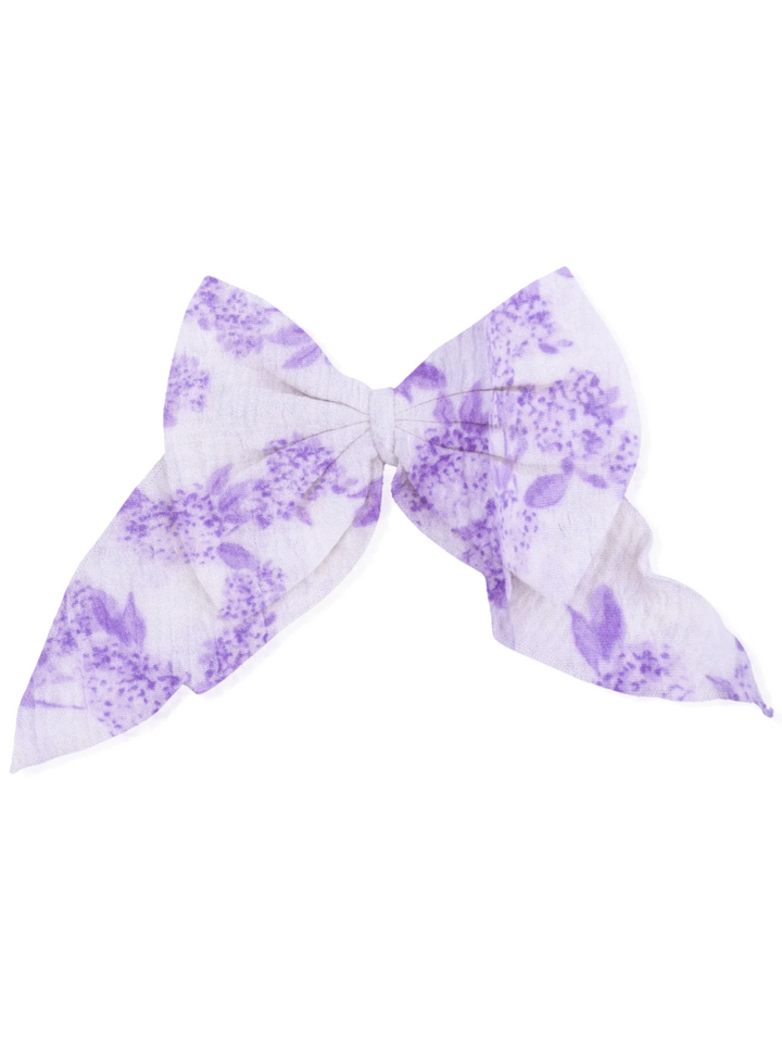 Purple floral patterned hair bow with a large, elegant shape on a white background.