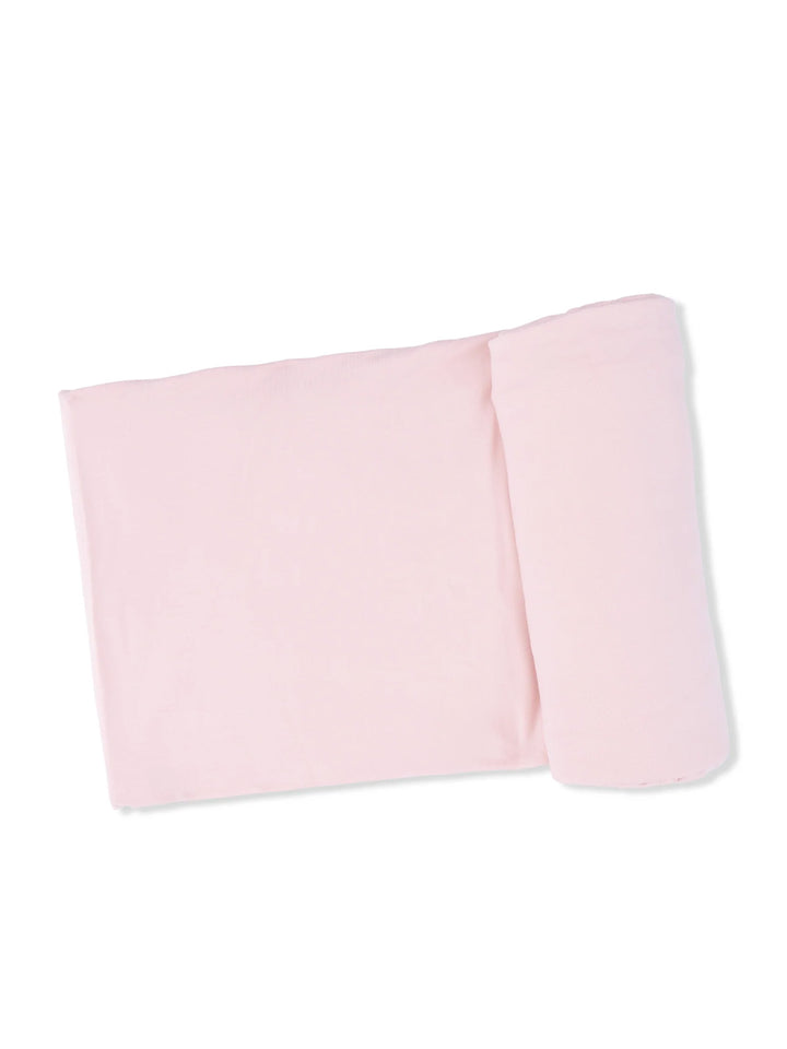 Light pink fabric rolled and laid flat on a white background, ideal for crafts or soft clothing projects.