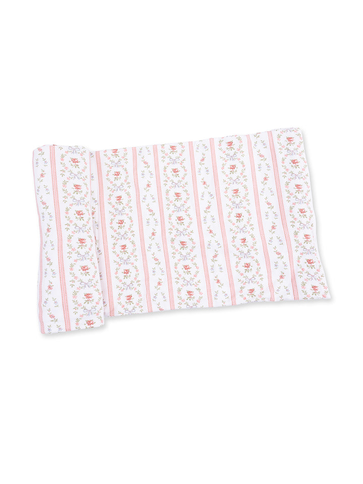 Floral patterned fabric in white, pink, and green with stripes and roses, ideal for home décor or crafting projects.
